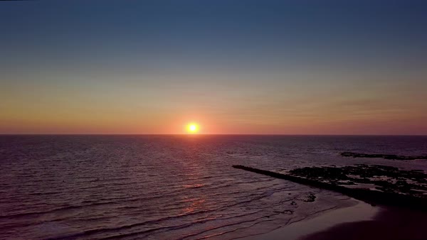 Aerial Shot Of Breathtaking View With Calm Ocean Waves On Background Aerial Shot Of Breathtaking View With Calm Ocean Waves On Background Colorful Sky And Sun Rising Above Water