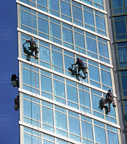 Window washers cleaning windows on skyscraper Stock Photo Dissolve