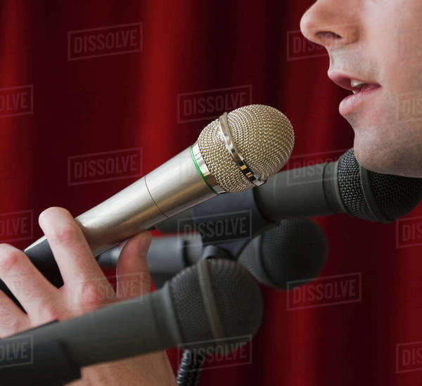 Man speaking into microphone Stock Photo Dissolve