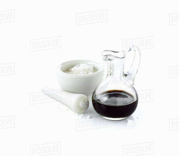 Coarse sea salt in a mortar and a carafe of balsamic vinegar Stock Photo Dissolve