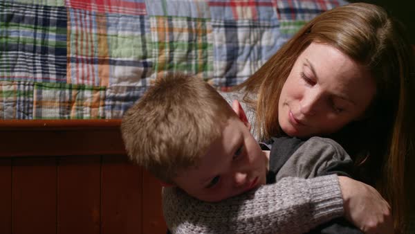 A Mother Comforts Her Son Who Looks Sad Stock Video Footage