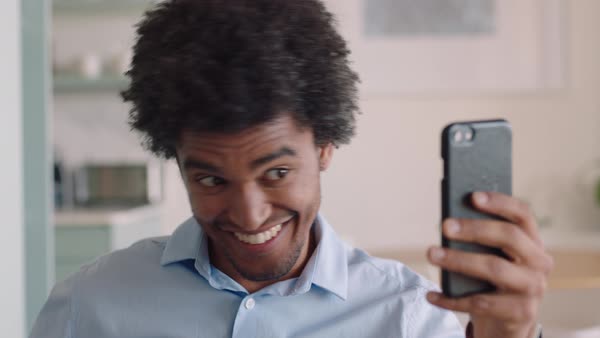 Attractive Mixed Race Man On A Video Chat Using Smartphone At Home