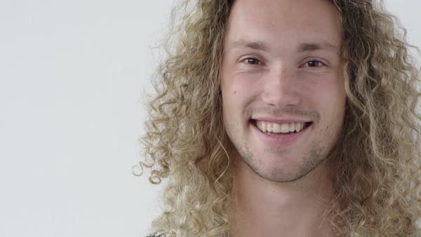 Portrait Of Attractive Young Man Smiling Confident Looking At