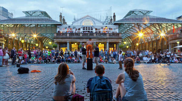 Crowd watching street performers at Covent Garden, London, England