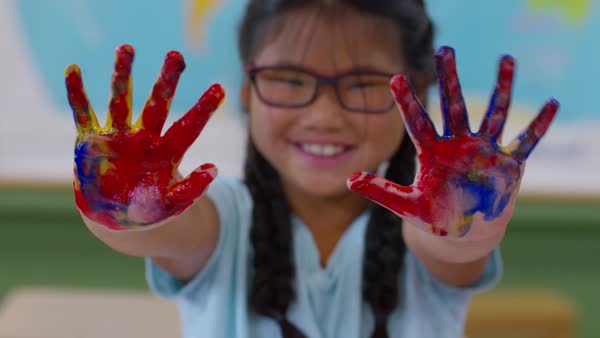 Young Girl Fingerpainting Holds Up Messy Hands Stock Video Footage Dissolve Young Girl Fingerpainting Holds Up Messy Hands Stock Video Footage Dissolve