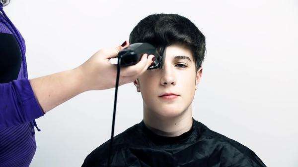 Young Man Visiting Hairdresser To Get A New Hair Cut Woman