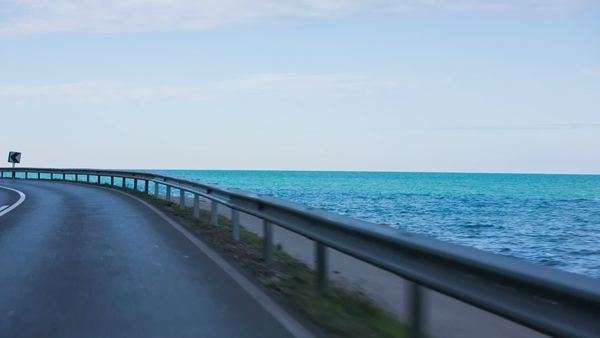 Road Beside The Blue Sea Shot From Inside Vehicle While Driving Beside