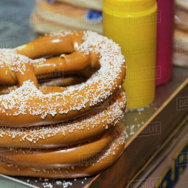 Salted pretzels and condiments on a food cart; New York City, New York