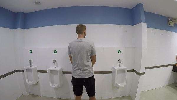 Man peeing in toilet. - Stock Video Footage - Dissolve