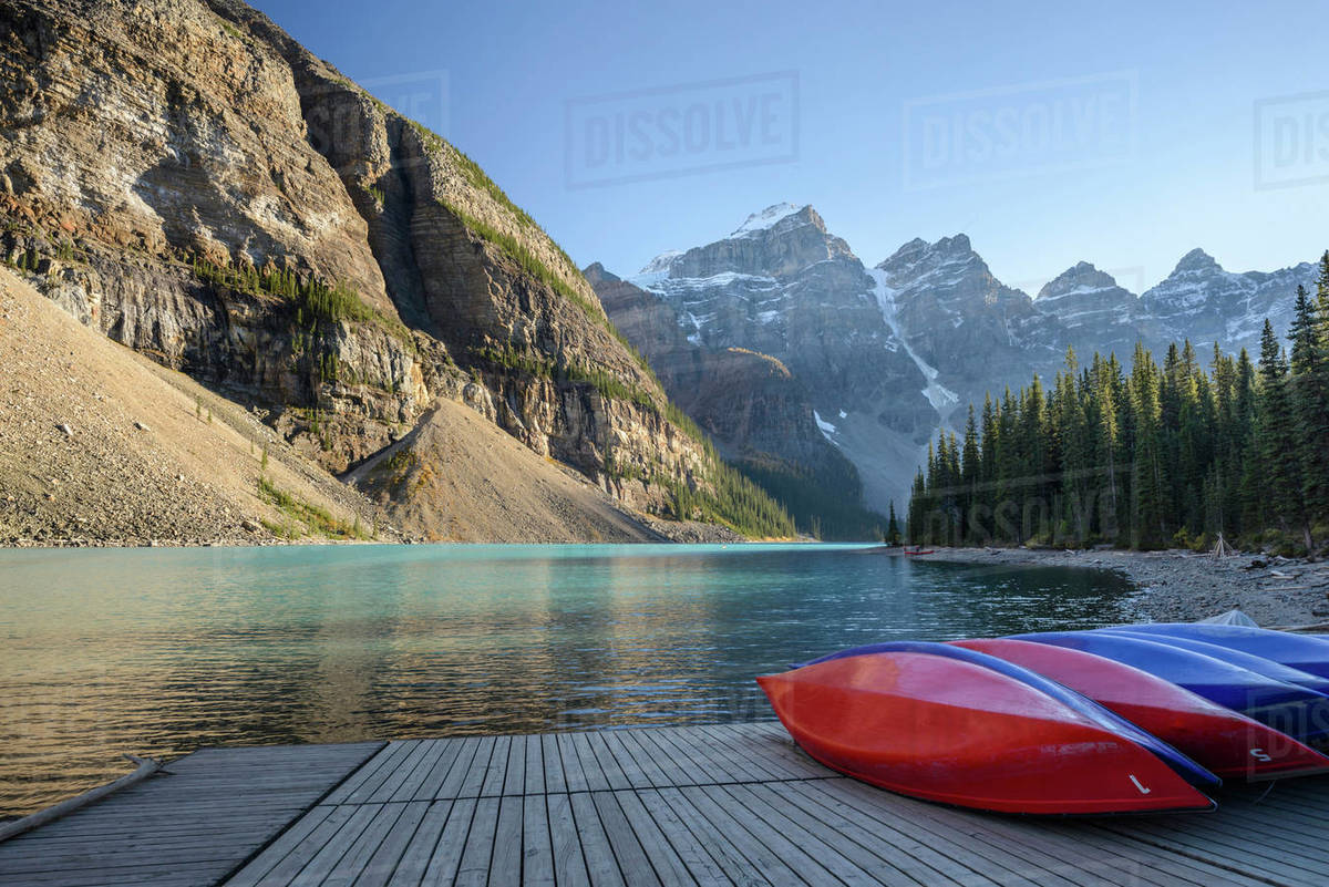 Canada, Alberta, Banff, Kayaks on jetty on Moraine Lake surrounded with