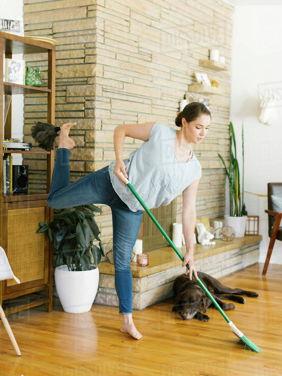 Woman sweeping and dusting Stock Photo Dissolve