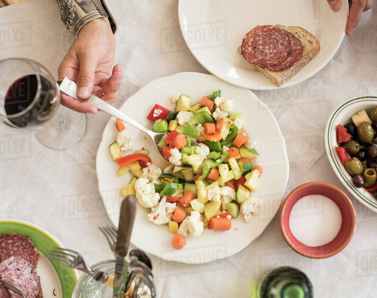 Hand serving salad Stock Photo Dissolve