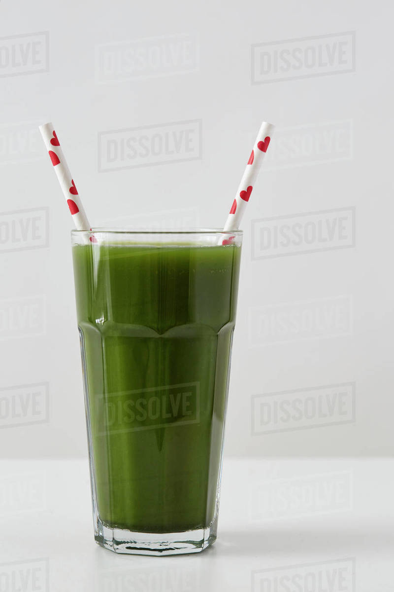 Green juice in cup with straws Stock Photo Dissolve