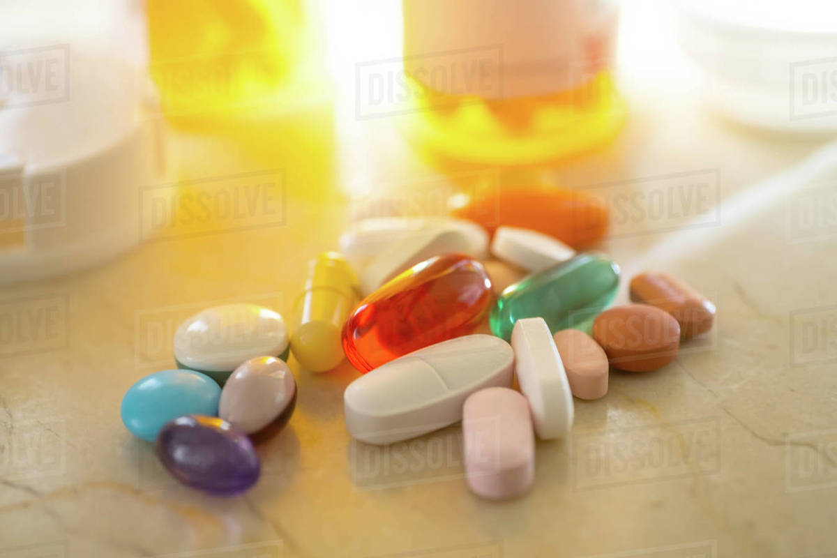 Pills and capsules on marble Stock Photo Dissolve