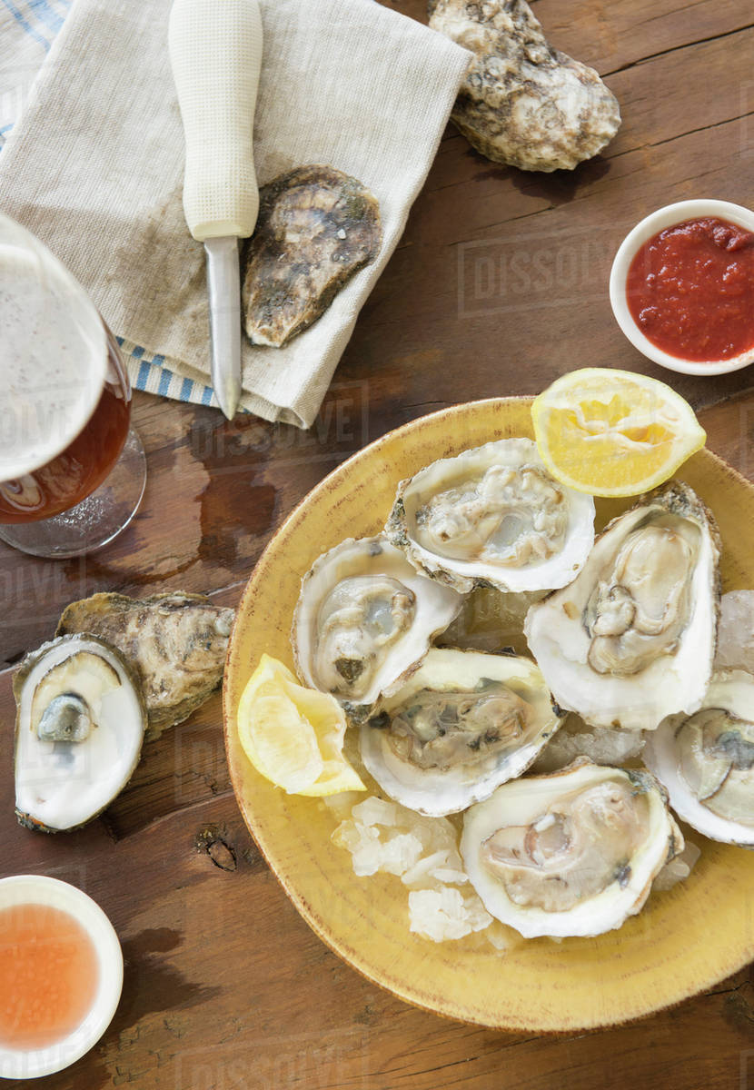 Elevated view of plate with oysters Stock Photo Dissolve