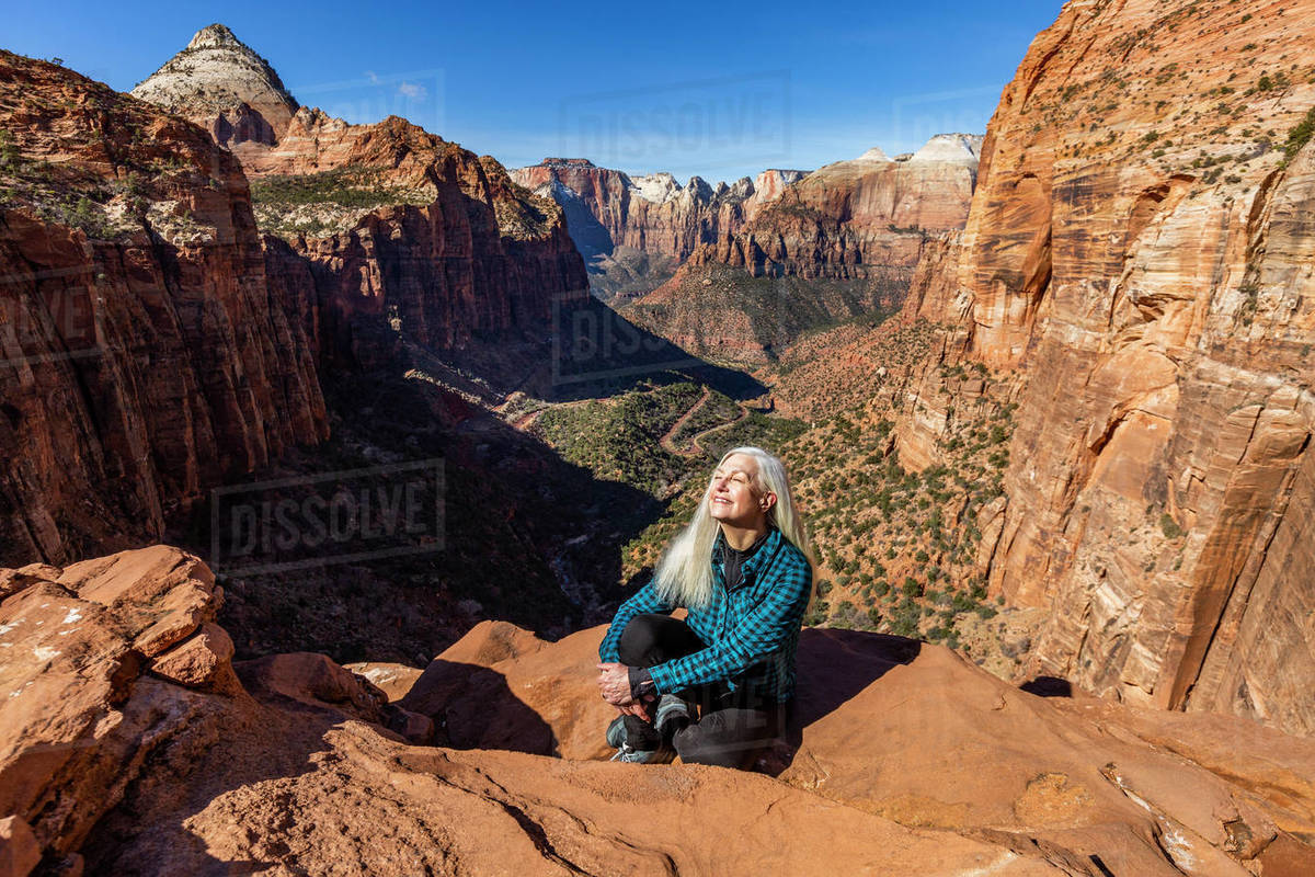 United States, Utah, Zion National Park, Senior woman at overlook above