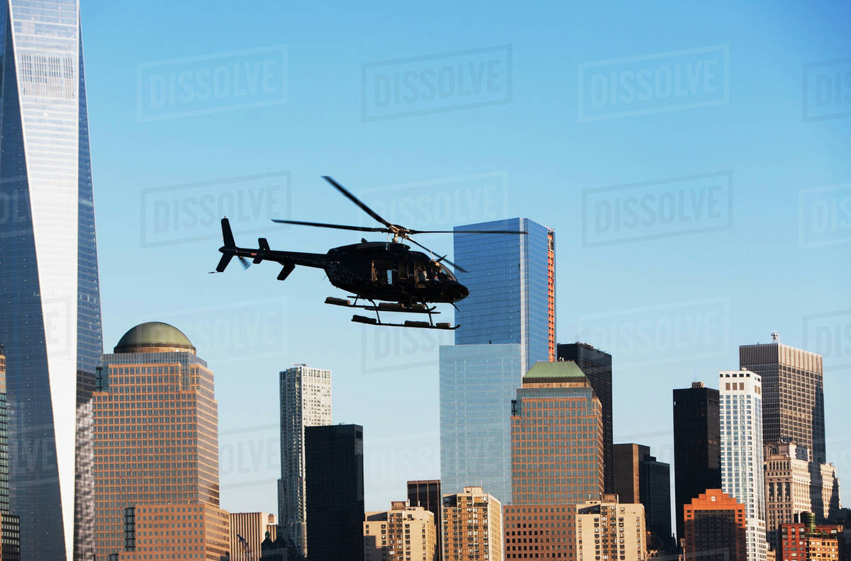 Helicopter flying over city Stock Photo Dissolve