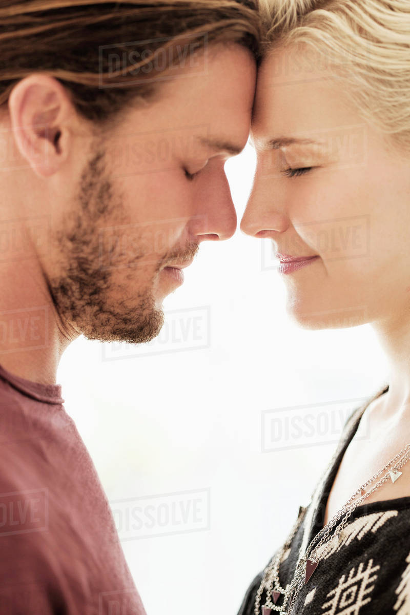 Couple rubbing noses on white background Stock Photo Dissolve