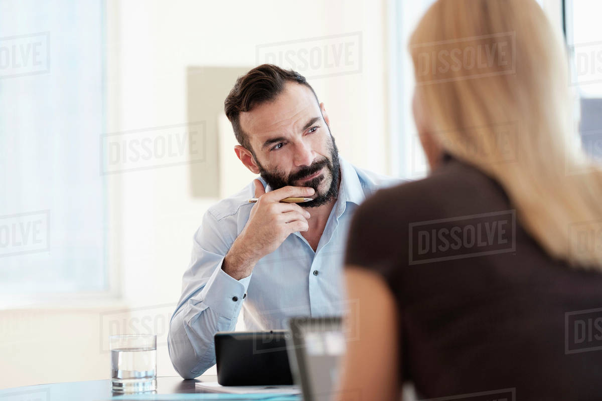 Man and woman sitting in office - Royalty-free Stock Photo | Dissolve