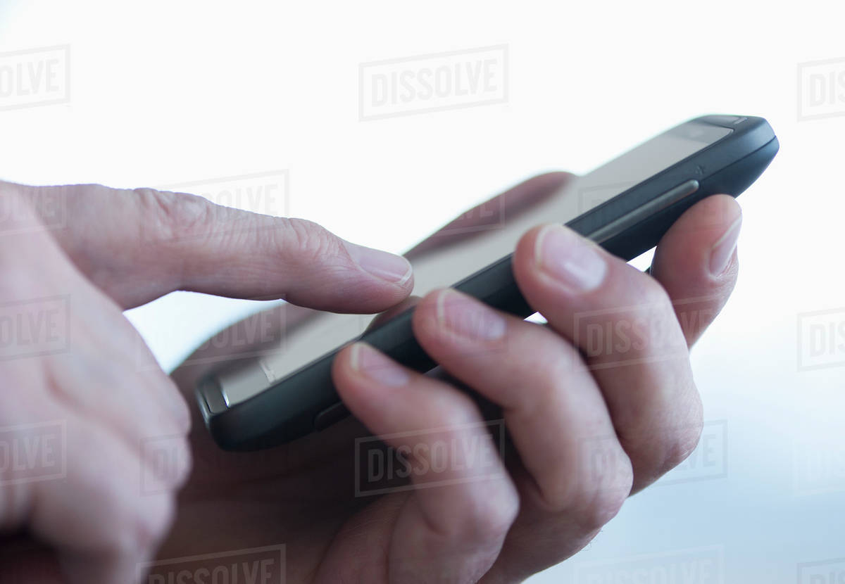 Close up of businessman's hands holding PDA Stock Photo Dissolve