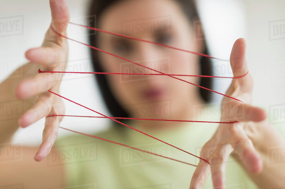 Woman playing cat's cradle Stock Photo Dissolve