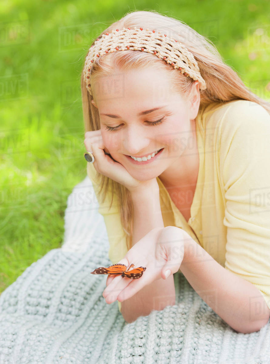 Woman holding butterfly on hand Stock Photo Dissolve