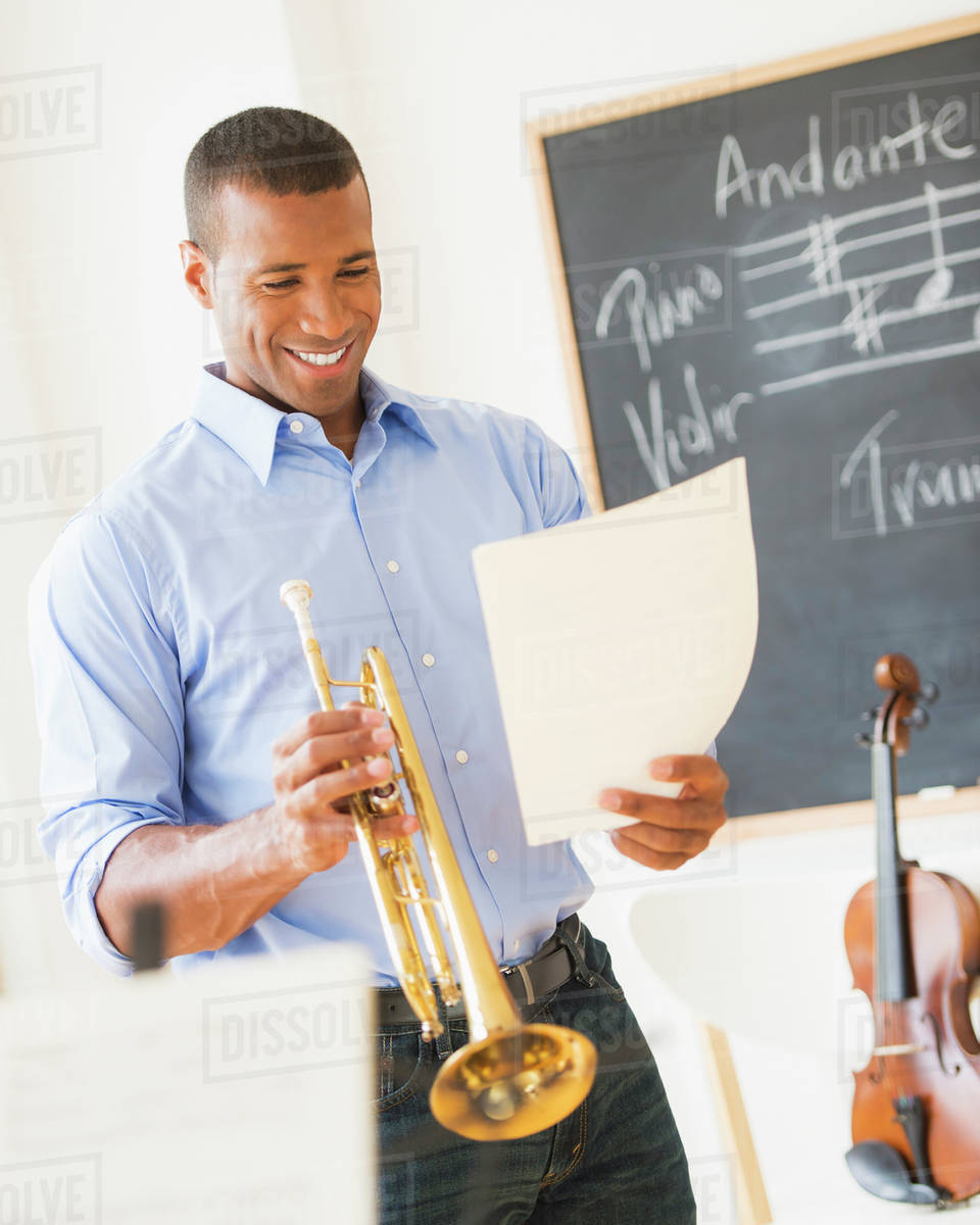 Music teacher with trombone Stock Photo Dissolve