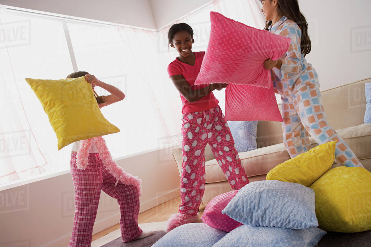 Three Girls 10 11 Having Pillow Fight At Slumber Party Stock