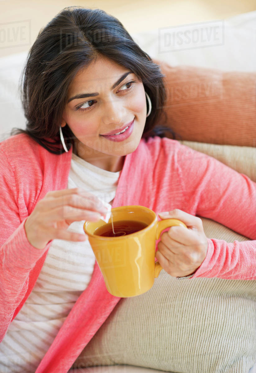 USA, New Jersey, Jersey City, Young attractive woman drinking tea from