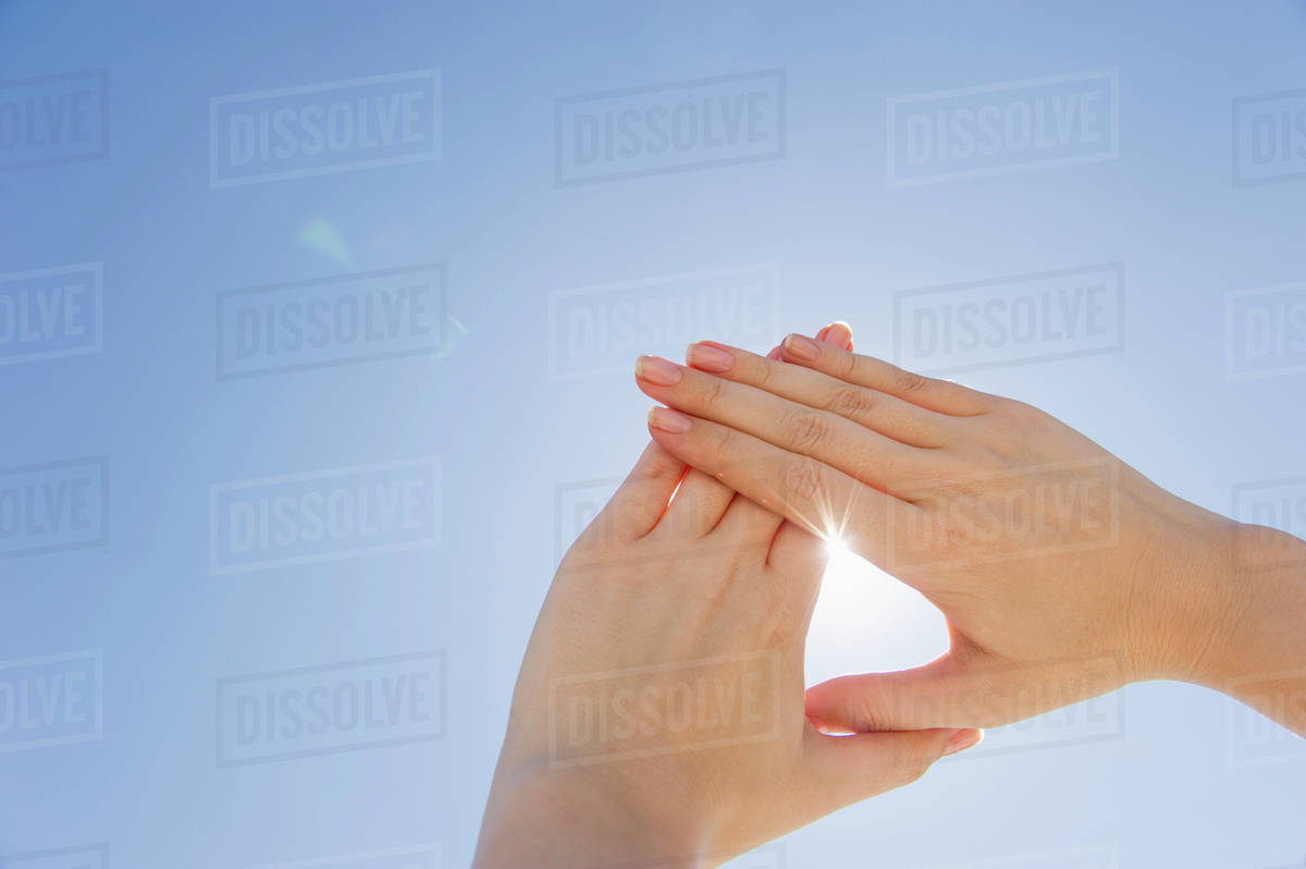Hands framing sunshine Stock Photo Dissolve