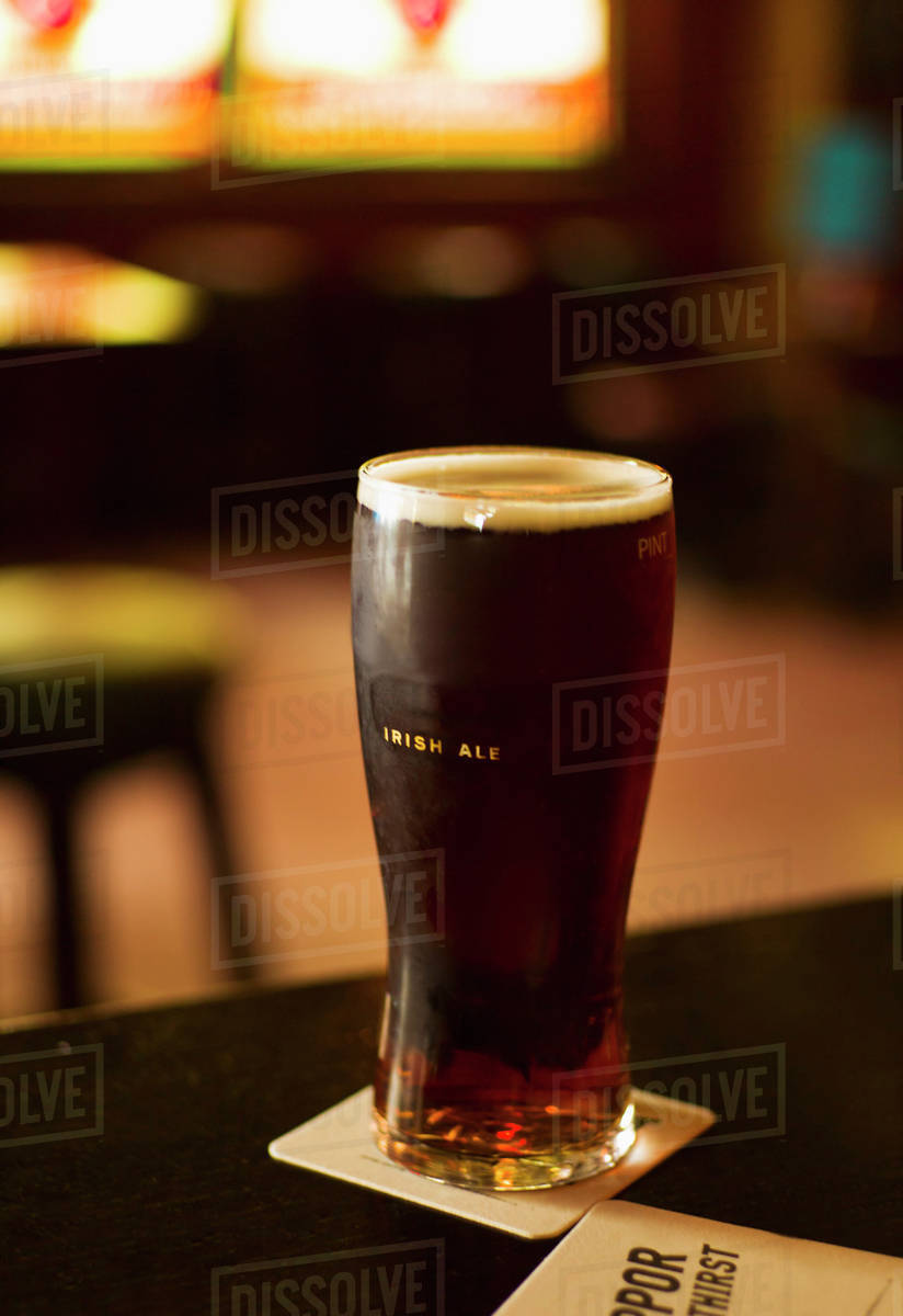 Glass of Irish ale in pub - Stock Photo - Dissolve