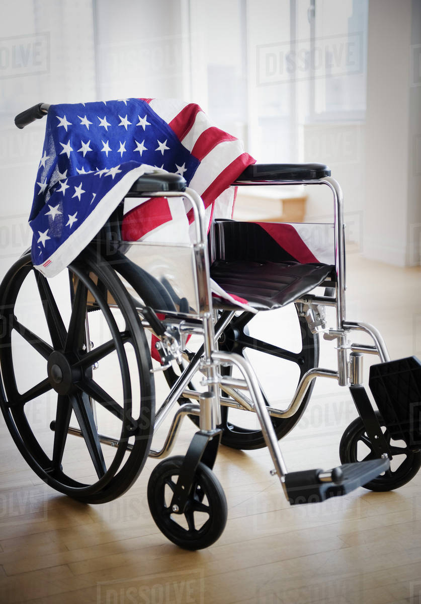 American flag draped on wheelchair - Stock Photo - Dissolve