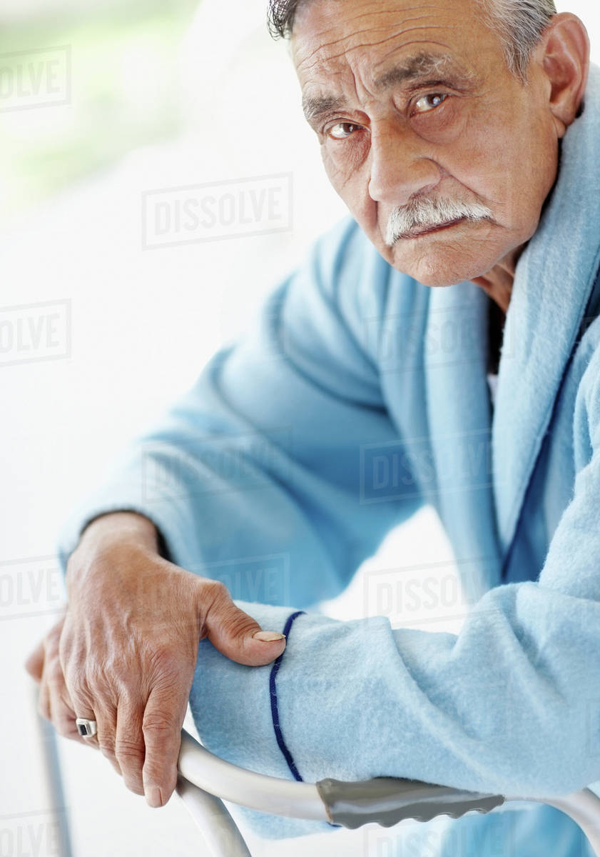 Elderly patient leaning on a walker Stock Photo Dissolve