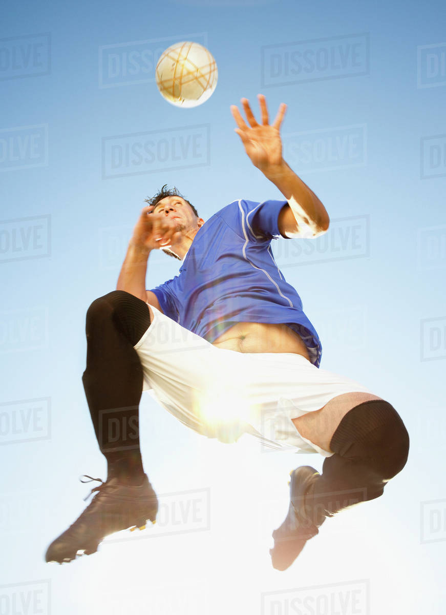 Soccer player heading the ball Stock Photo Dissolve