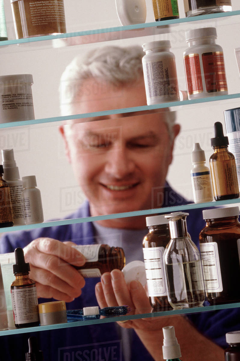 Man in front of medicine Stock Photo Dissolve