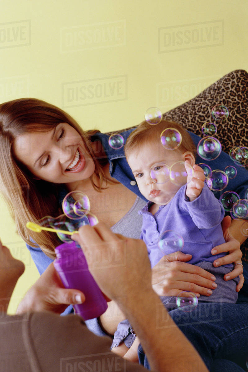 Baby playing with bubbles Stock Photo Dissolve