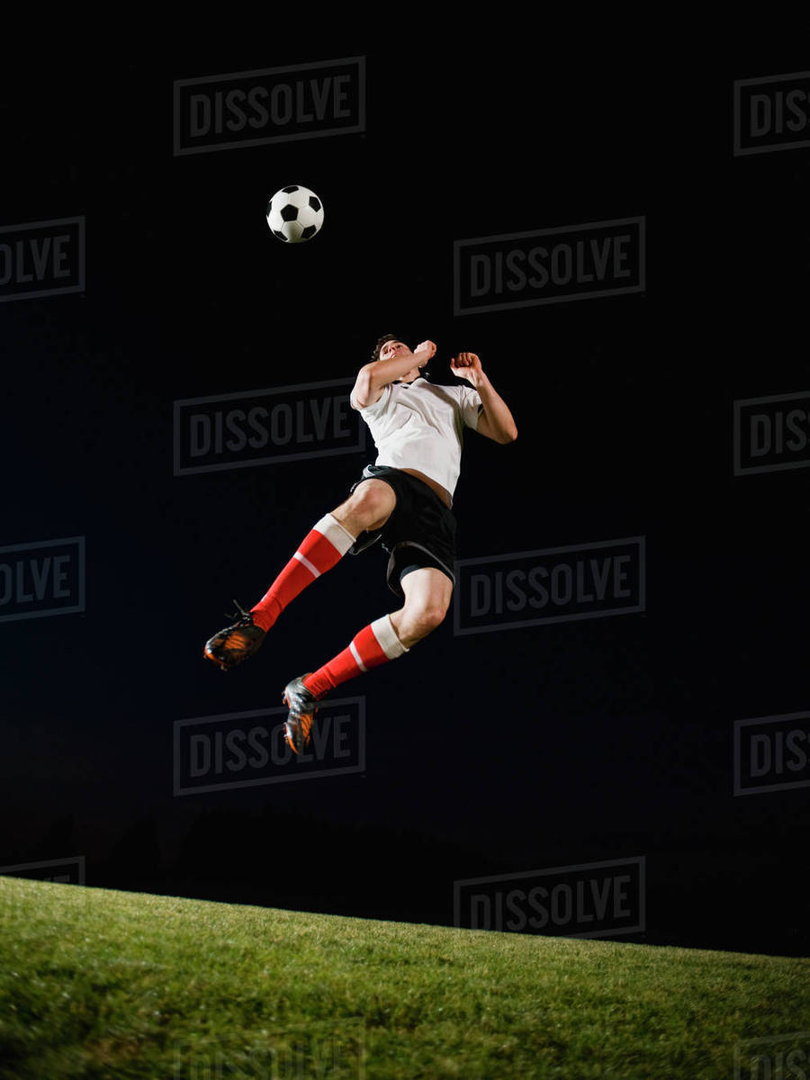 Soccer player heading ball Stock Photo Dissolve