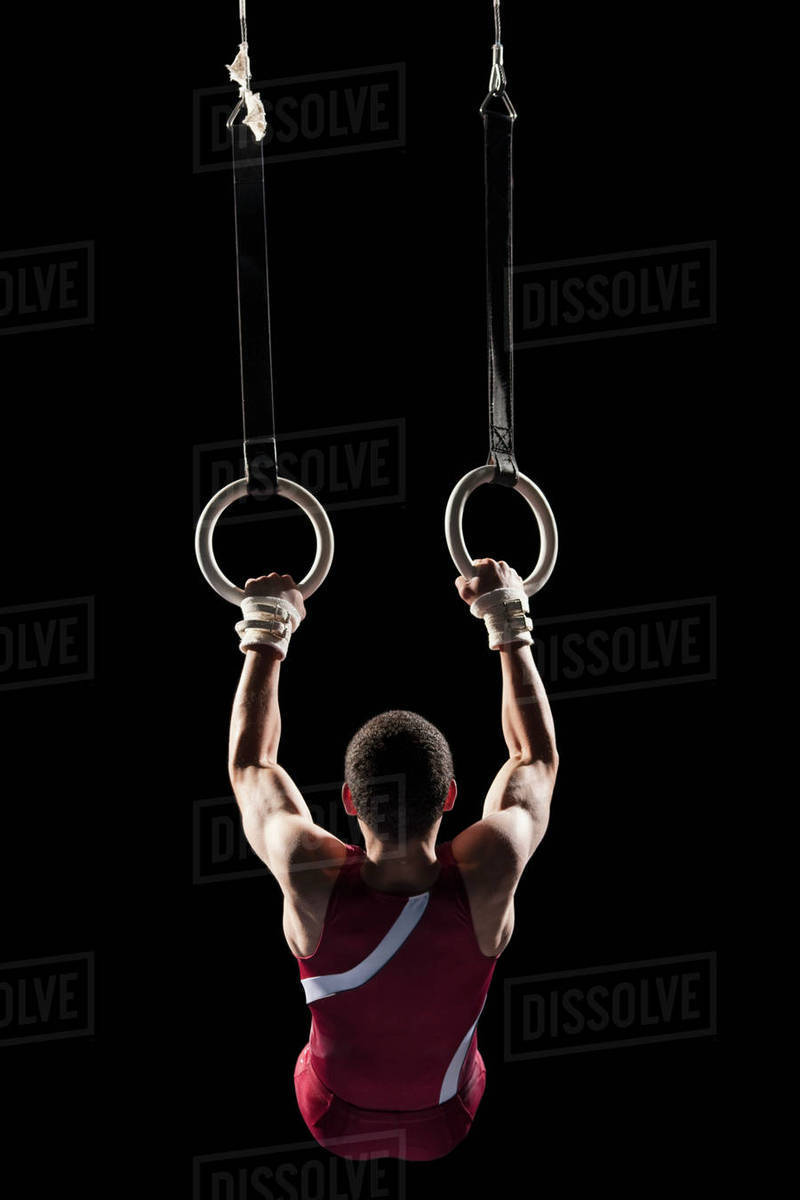 Gymnast swinging from rings Stock Photo Dissolve
