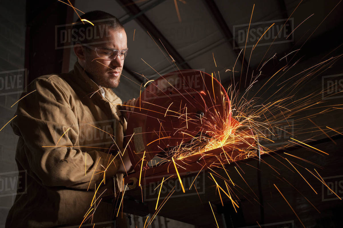 Steel grinder working in metal shop Stock Photo Dissolve