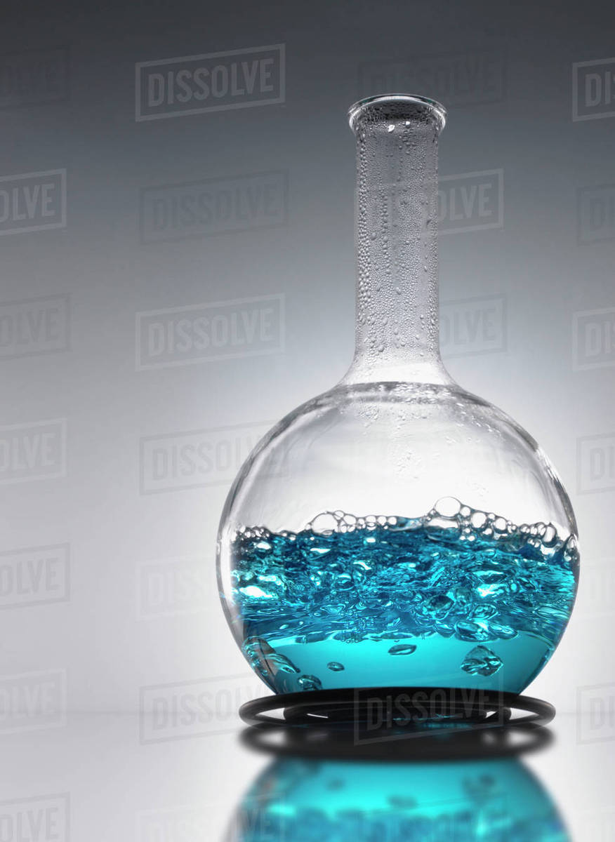 Beaker of blue mixture Stock Photo Dissolve