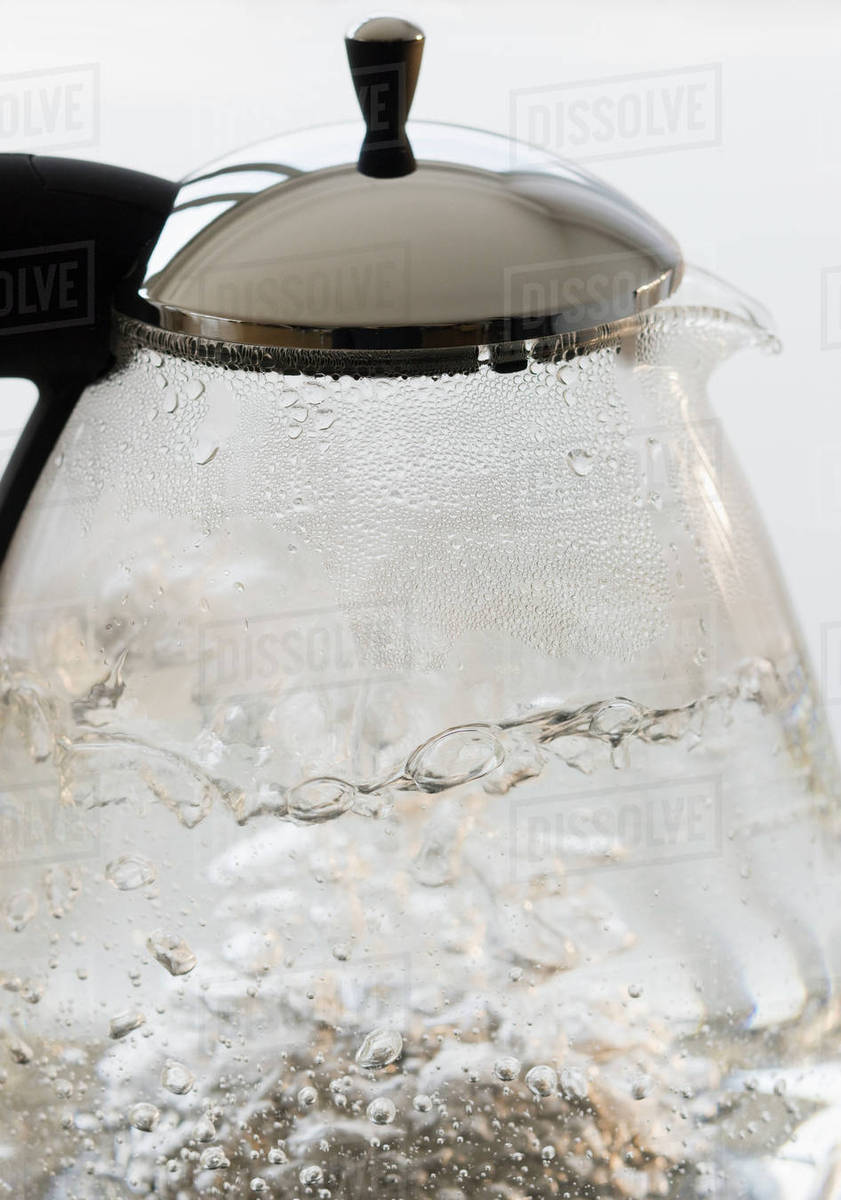 Close up of boiling water in tea pot Stock Photo Dissolve
