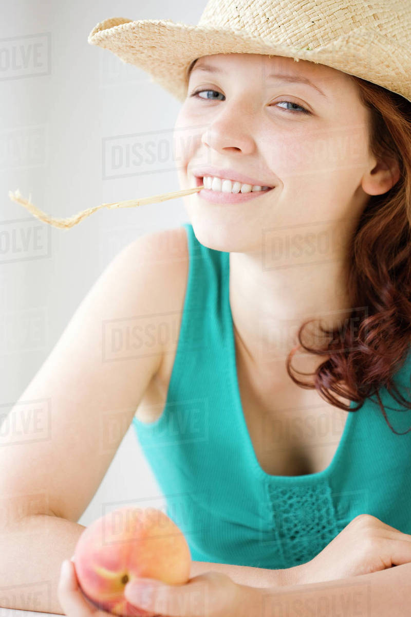 Teenage girl chewing on wheat stalk Stock Photo Dissolve