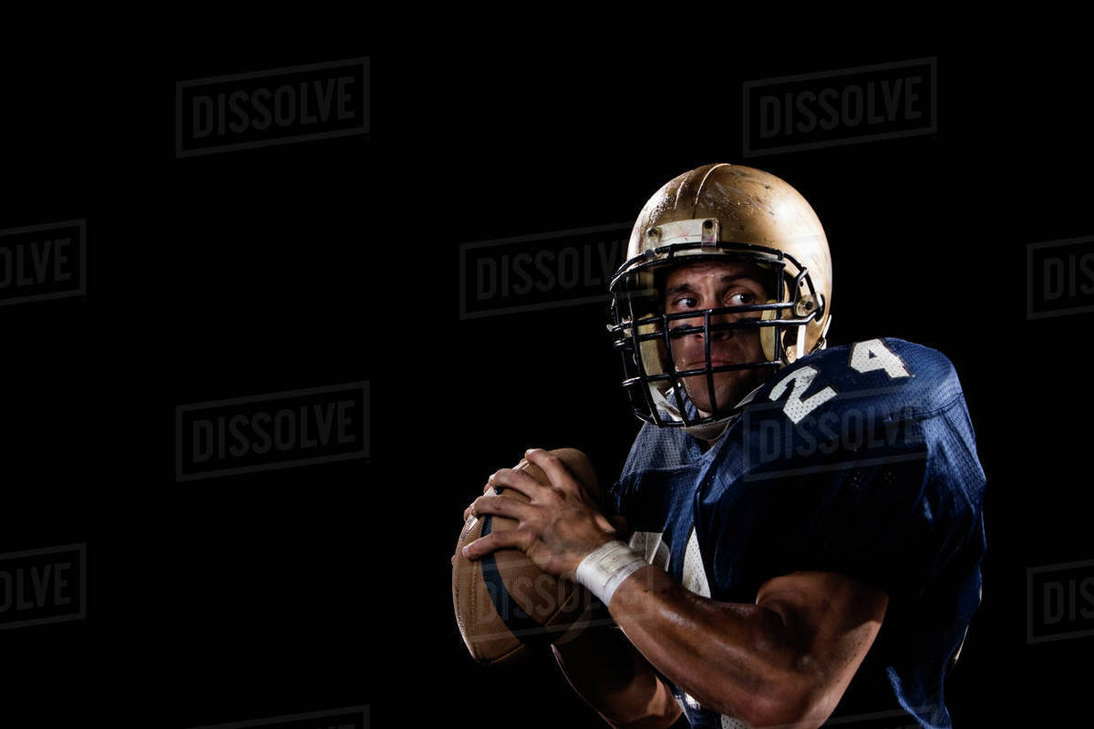 Quarterback preparing to throw football Stock Photo Dissolve