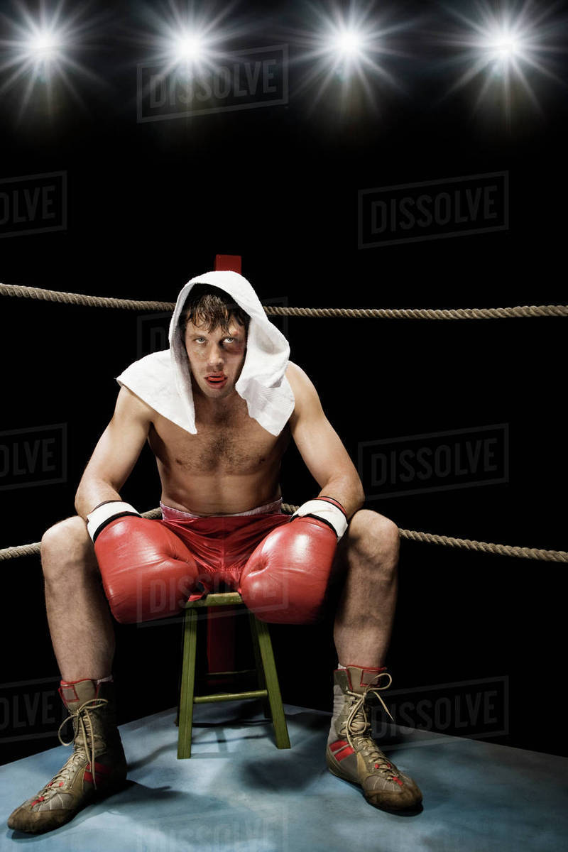 Boxer sitting on stool in corner of boxing ring Stock Photo Dissolve