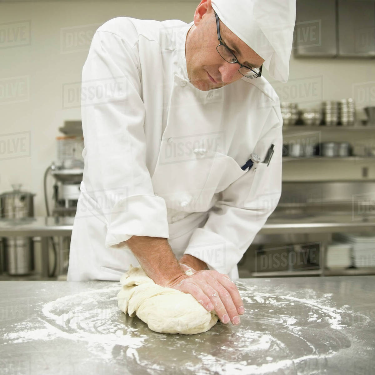Baker kneading bread dough Stock Photo Dissolve