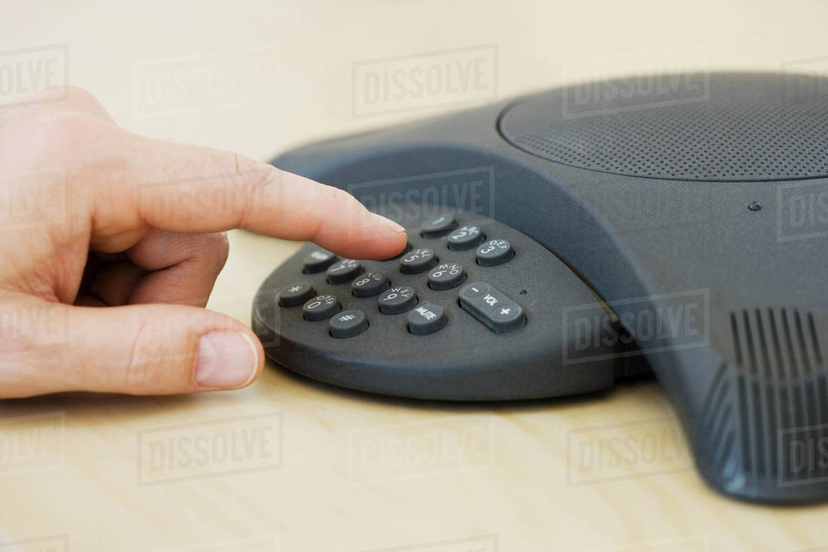 Businessman dialing conference call Stock Photo Dissolve