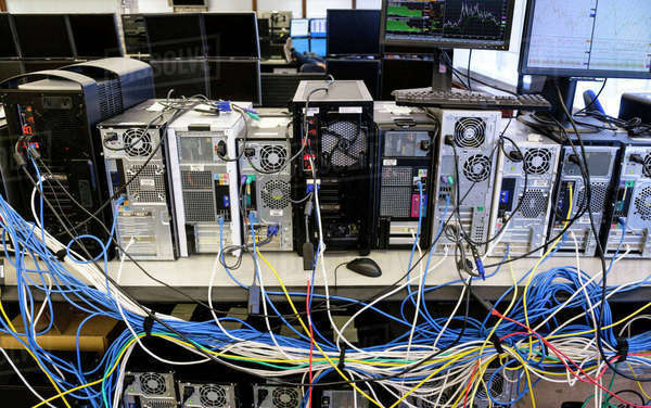 Computers connected with many cables - Royalty-free Stock Photo | Dissolve