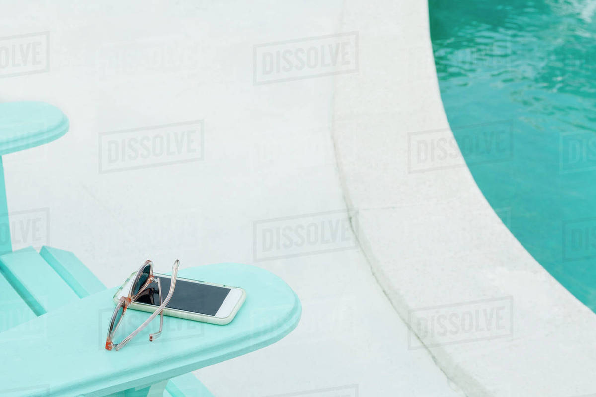 Sunglasses And Smart Phone On Deck Chair Stock Photo