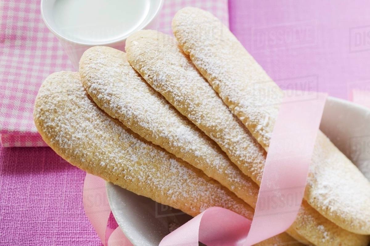 Sponge fingers with pink ribbon Stock Photo Dissolve