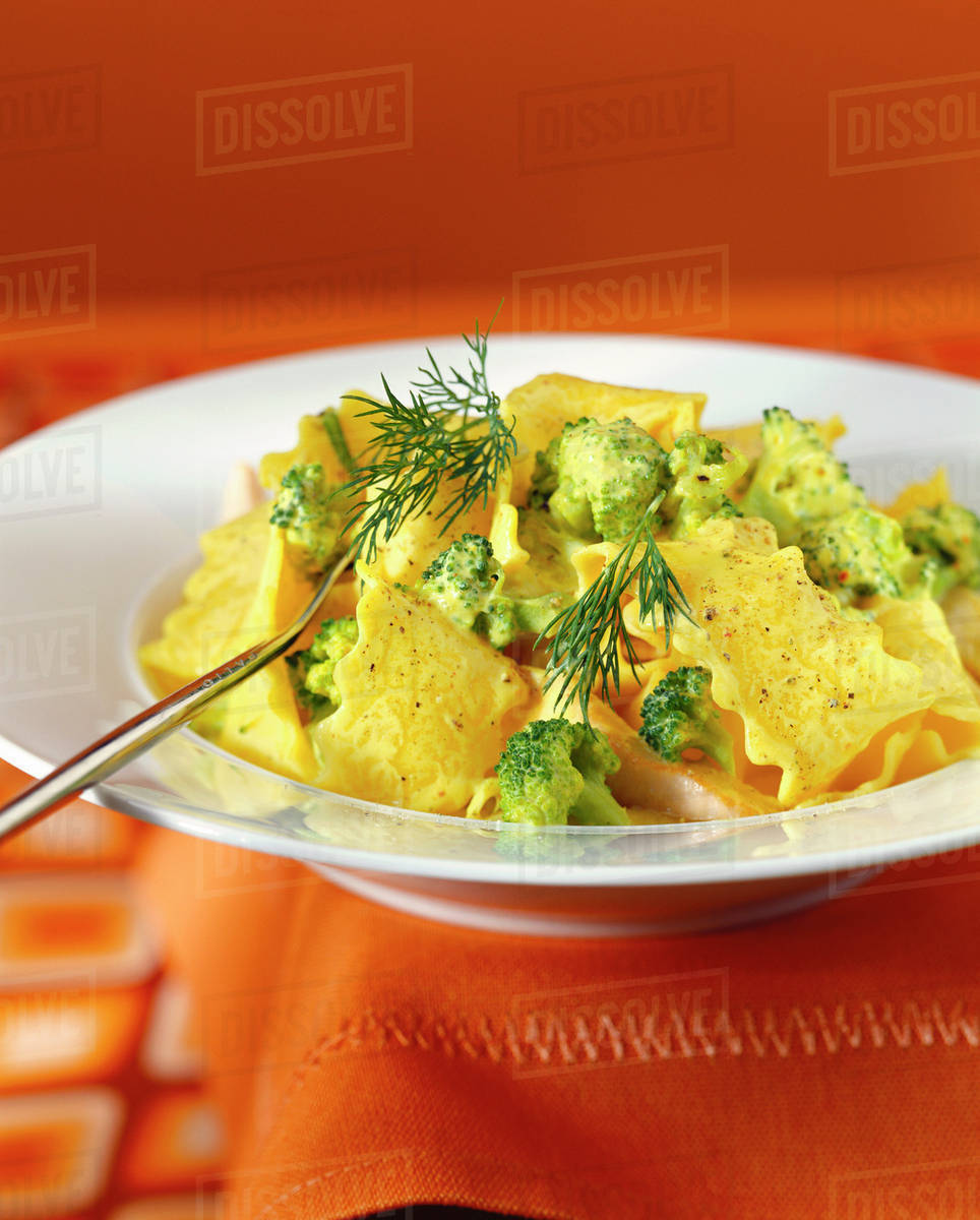 Homemade noodles with broccoli, fish & saffron sauce Stock Photo Dissolve